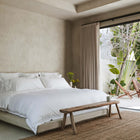 Luxury organic cotton bedding by Rest & Reset styled in a serene bedroom, designed to support deeper and more restful sleep