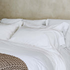 Organic cotton pillowcases by Rest & Reset styled on a minimalist bed, creating a calm, luxury sleep environment for nightly rest