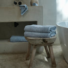 Ritual Bath Sheet Set by Rest & Reset styled on a bathroom bench, adding warmth and relaxed luxury to the space