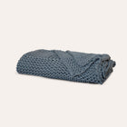 Still Throw Blanket by Rest & Reset neatly folded, showcasing minimalist design and premium organic cotton fabric