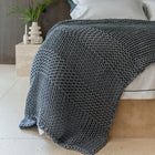 Still Throw Blanket by Rest & Reset draped over furniture, adding warmth, texture, and a serene aesthetic to the space