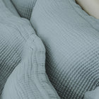 Close-up of organic cotton fabric on Murmur Euro Sham by Rest & Reset, highlighting softness and natural texture