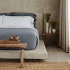 Murmur Quilt by Rest & Reset styled with a bedside bench, emphasizing relaxed luxury and functionality