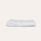 Murmur Quilt by Rest & Reset folded neatly, presenting breathable organic cotton material