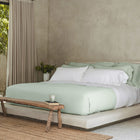 Waves Pillow Sham by Rest & Reset styled on a wooden bench, emphasizing relaxed luxury and everyday comfort