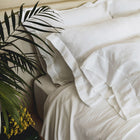 Waves Pillow Sham by Rest & Reset styled with natural elements, enhancing a calm and organic bedroom feel