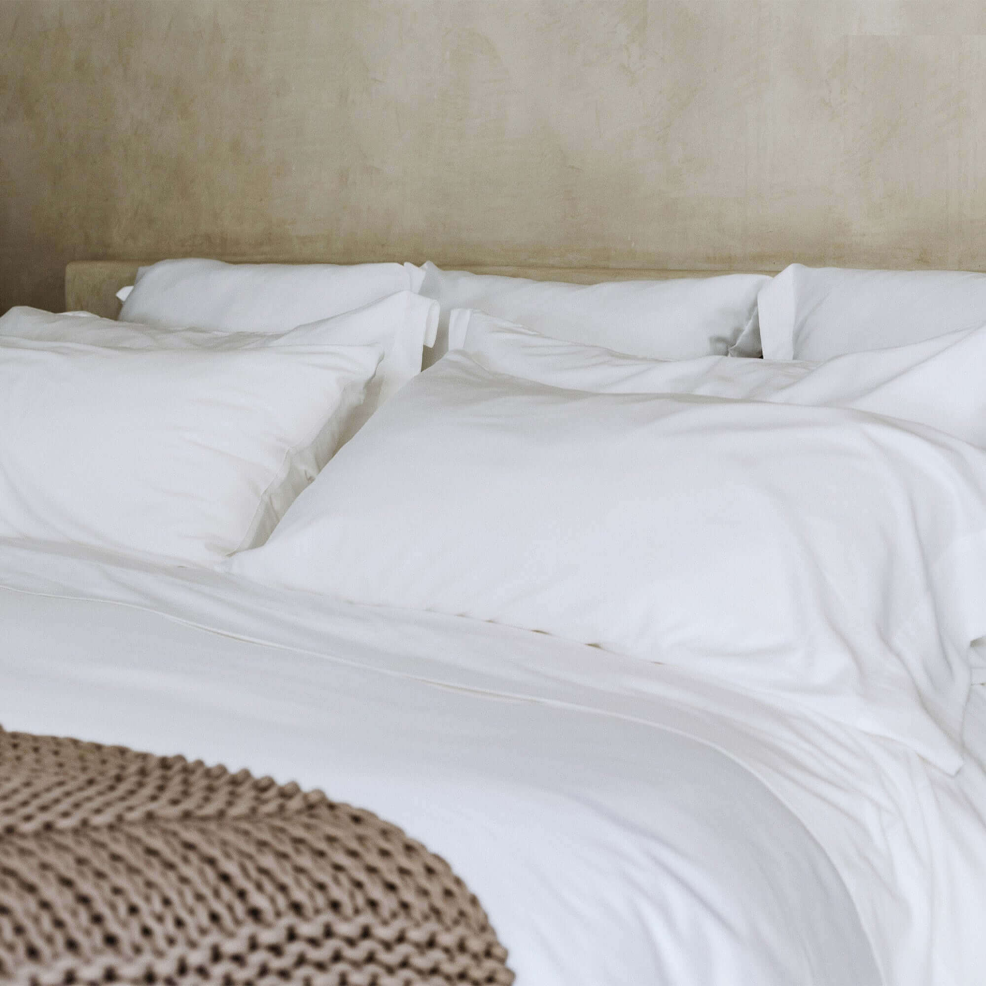 Classic organic cotton pillowcases by Rest & Reset styled on a neatly made bed, creating a clean and restful sleep environment