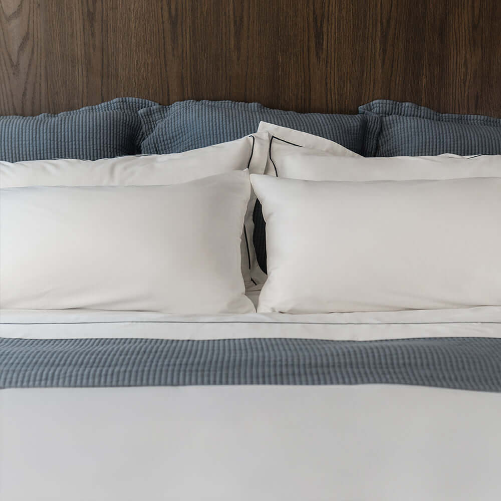 Serene organic cotton pillowcases by Rest & Reset styled on a full bed, designed for deep rest and nightly comfort