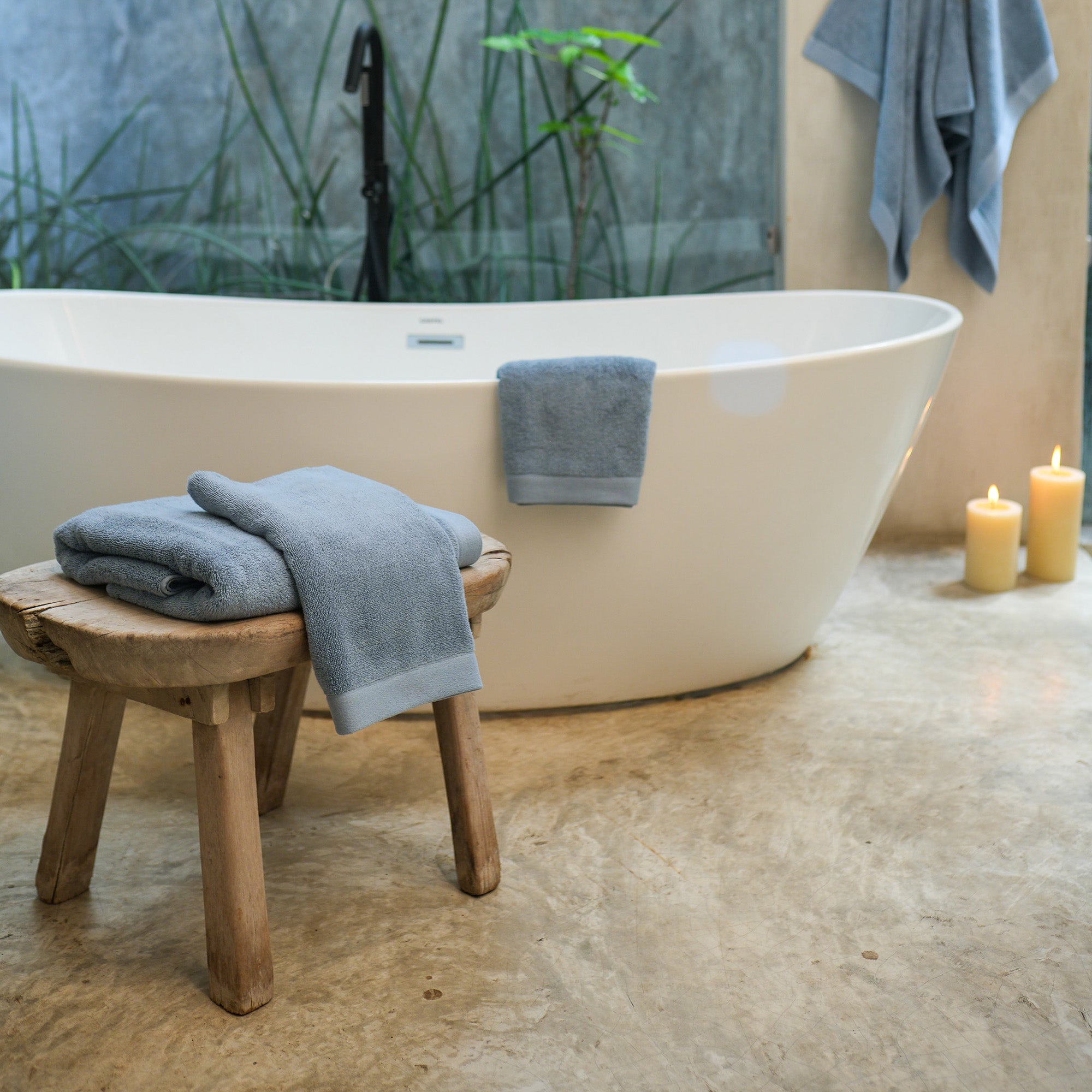 Oasis Bath Sheet Set by Rest & Reset styled on a bathroom bench, reinforcing a relaxed and inviting atmosphere