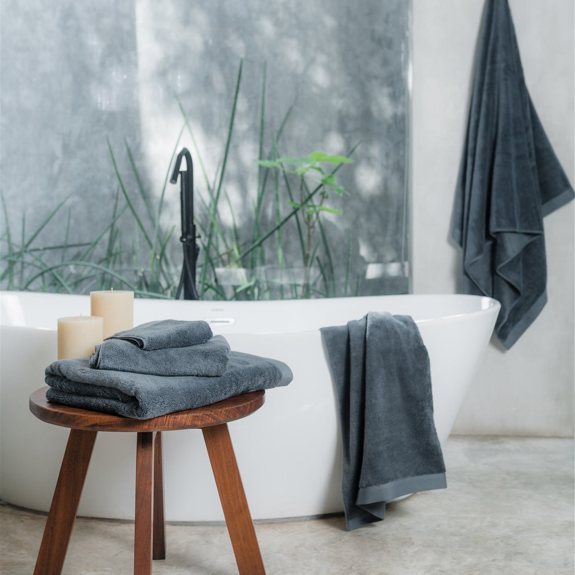 Oasis Bath Sheet Set by Rest & Reset styled near a window, enhancing a fresh and calming bathroom atmosphere