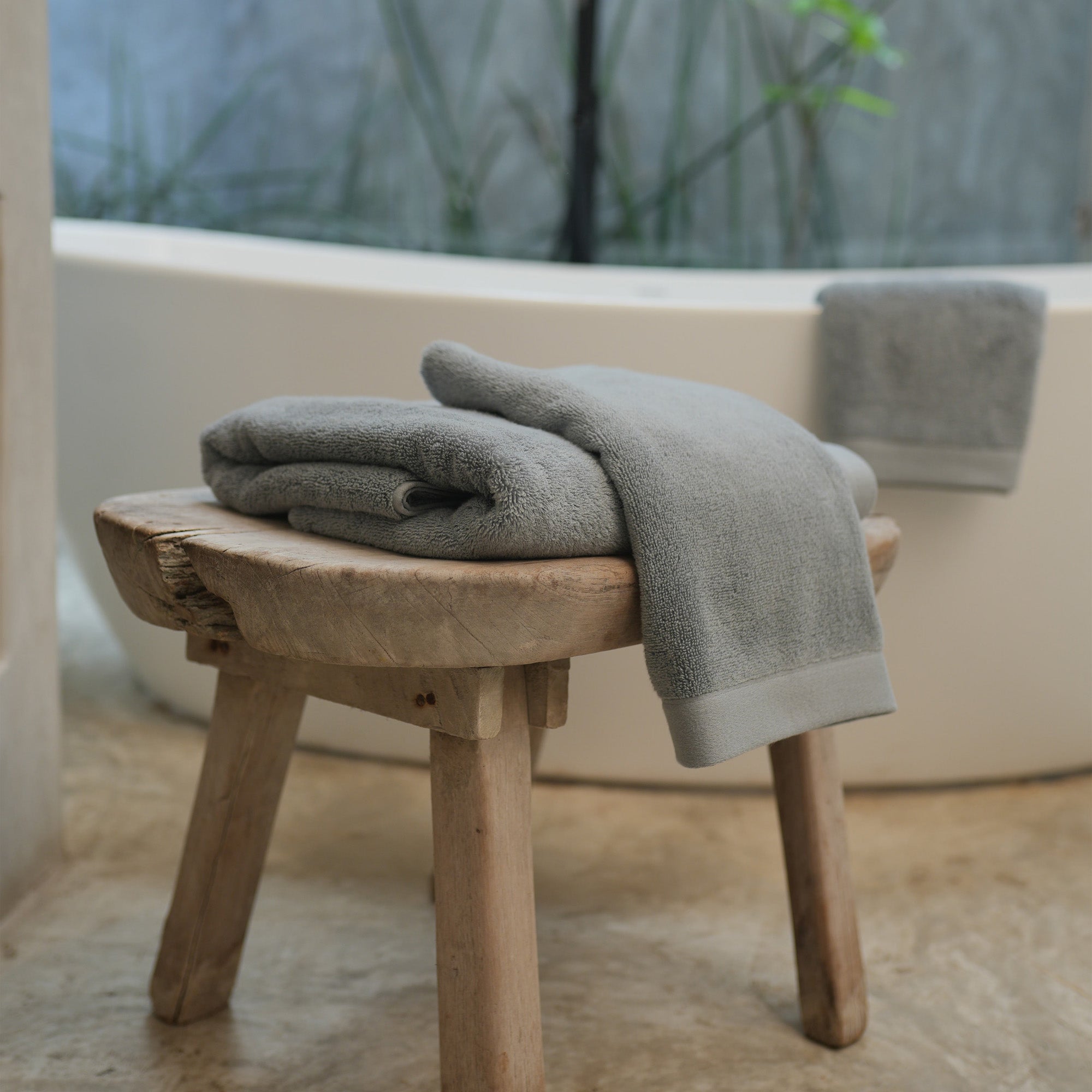 Oasis Bath Towels Pair by Rest & Reset styled on a bathroom bench, adding warmth and relaxed luxury to the space