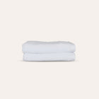Oasis Bath Towels Pair by Rest & Reset stacked neatly, presenting absorbent towels designed for daily routines