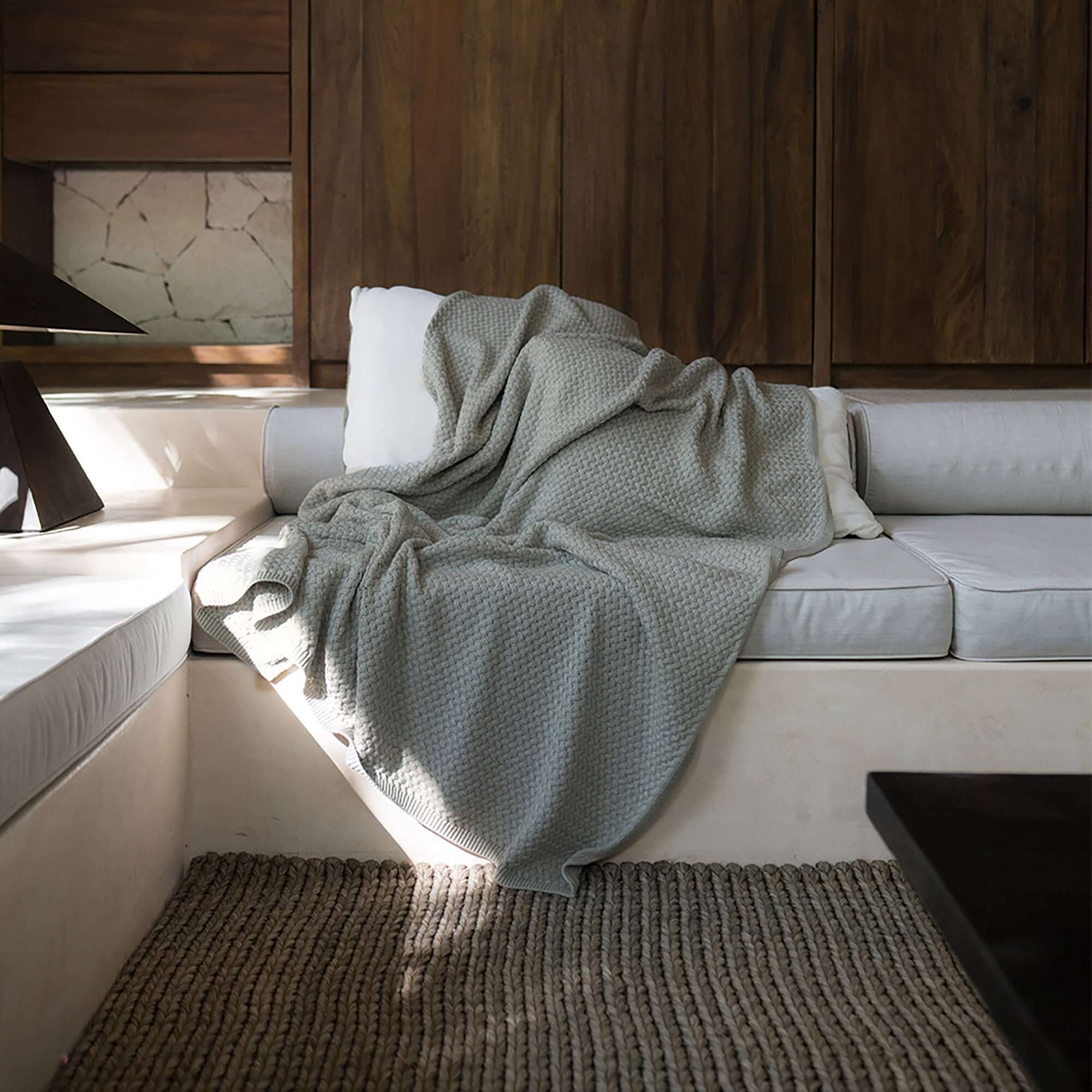 Pause Throw Blanket by Rest & Reset draped casually in natural light, emphasizing softness and mindful comfort