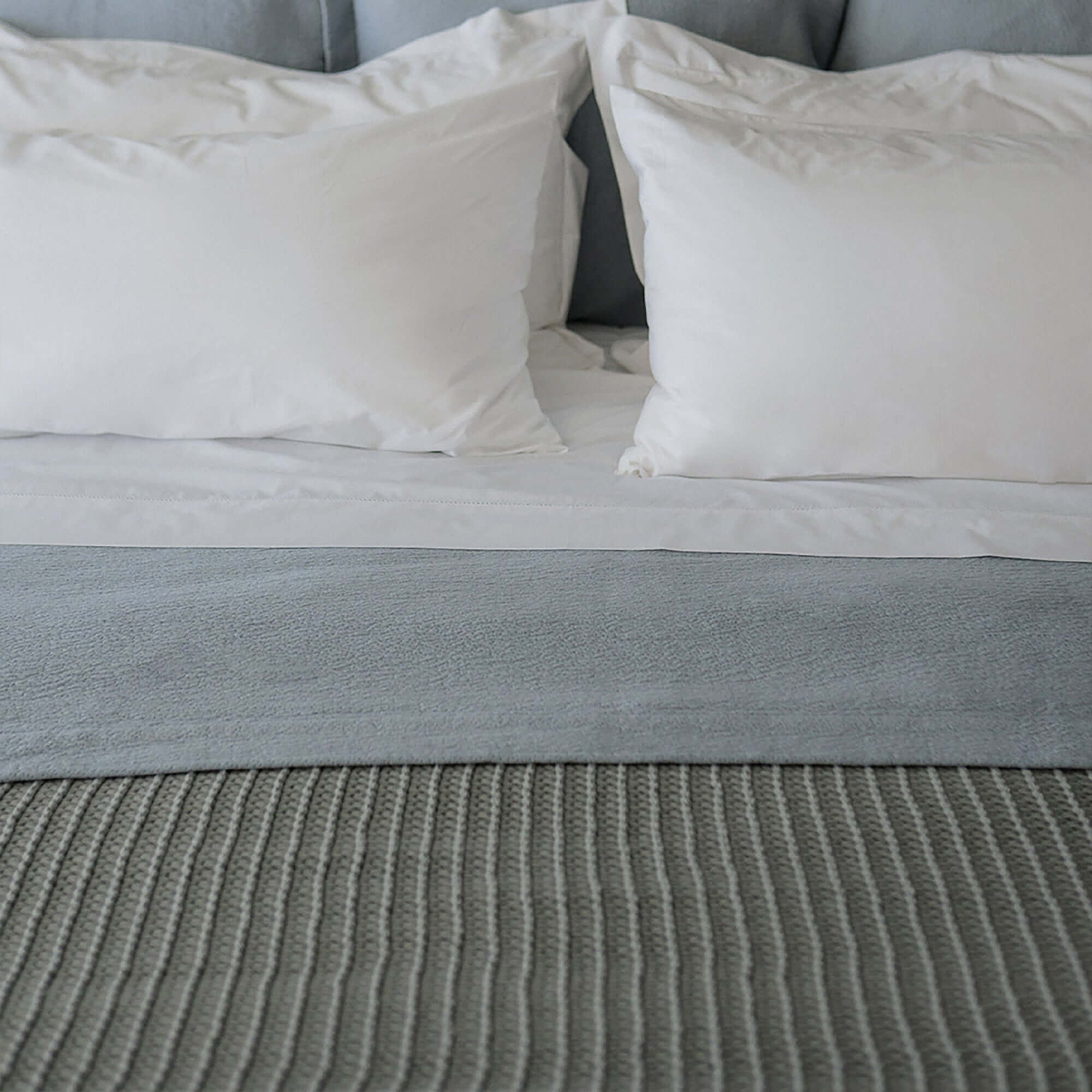 Whisper Throw Blanket by Rest & Reset styled in a serene bedroom, supporting warmth, rest, and everyday comfort
