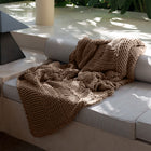 Still Throw Blanket by Rest & Reset styled in a cozy living space, creating a sense of calm and mindful relaxation