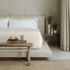 Murmur Quilt by Rest & Reset styled with warm wood accents, emphasizing comfort and timeless design