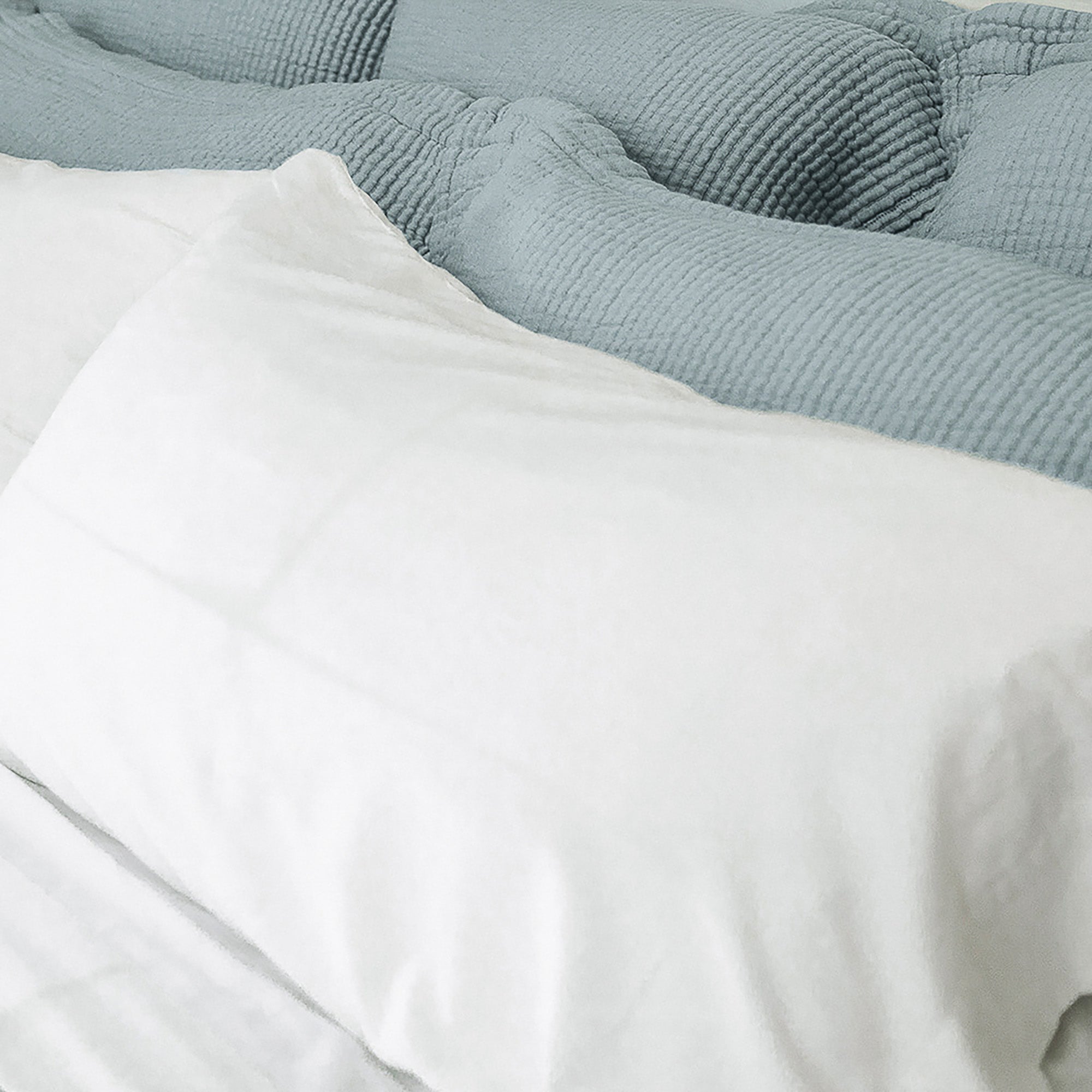 Close-up of organic cotton fabric on Murmur Pillow Sham by Rest & Reset, highlighting smooth texture and softness