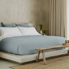 Murmur Quilt by Rest & Reset layered on a made bed, adding softness and depth to the sleep space