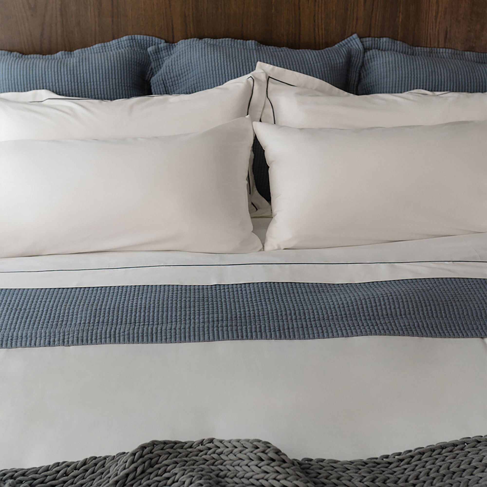 Murmur Pillow Sham by Rest & Reset layered on bedding, emphasizing softness and organic cotton texture