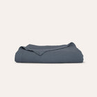 Murmur Quilt by Rest & Reset shown folded in an alternate tone, maintaining a relaxed and modern aesthetic