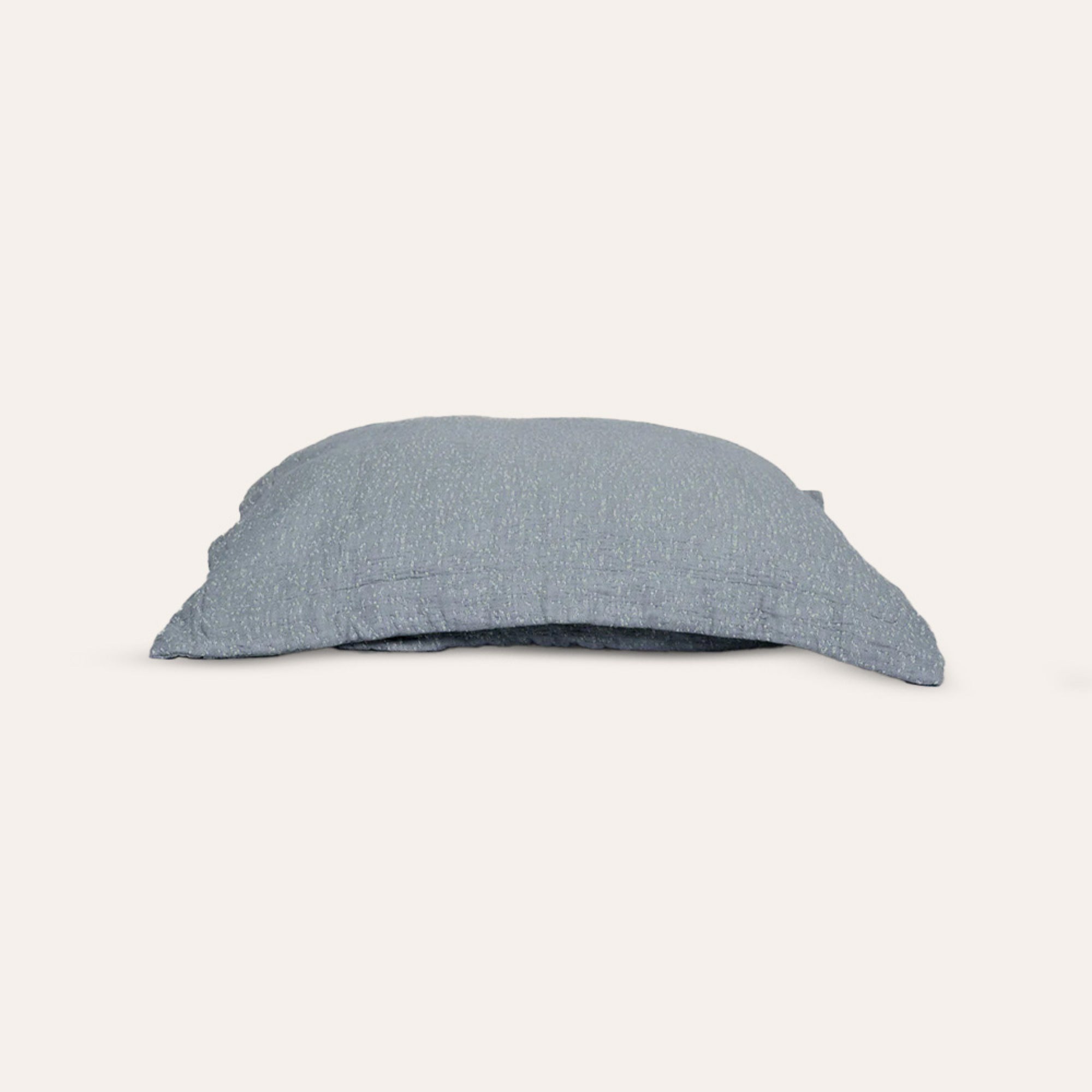 Veil Pillow Sham by Rest & Reset neatly folded, showcasing refined construction and premium organic cotton fabric