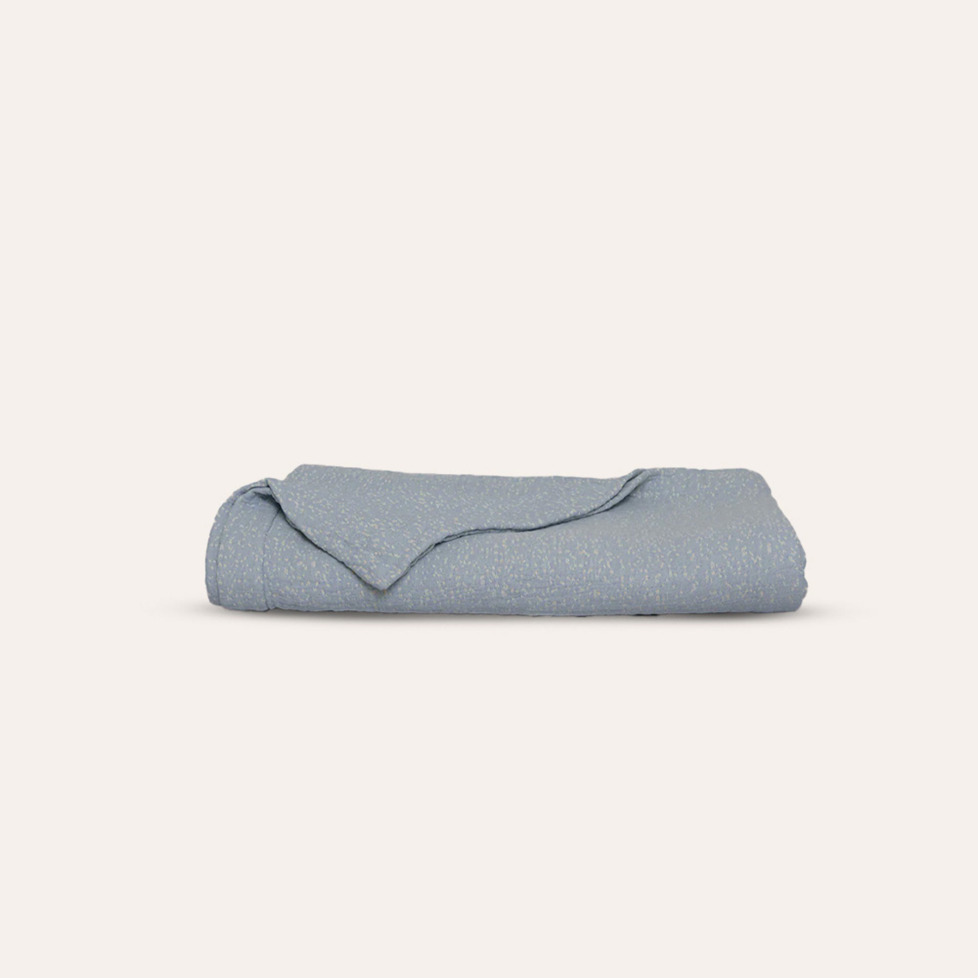 Veil Quilt by Rest & Reset neatly folded, showcasing clean lines and premium organic cotton fabric