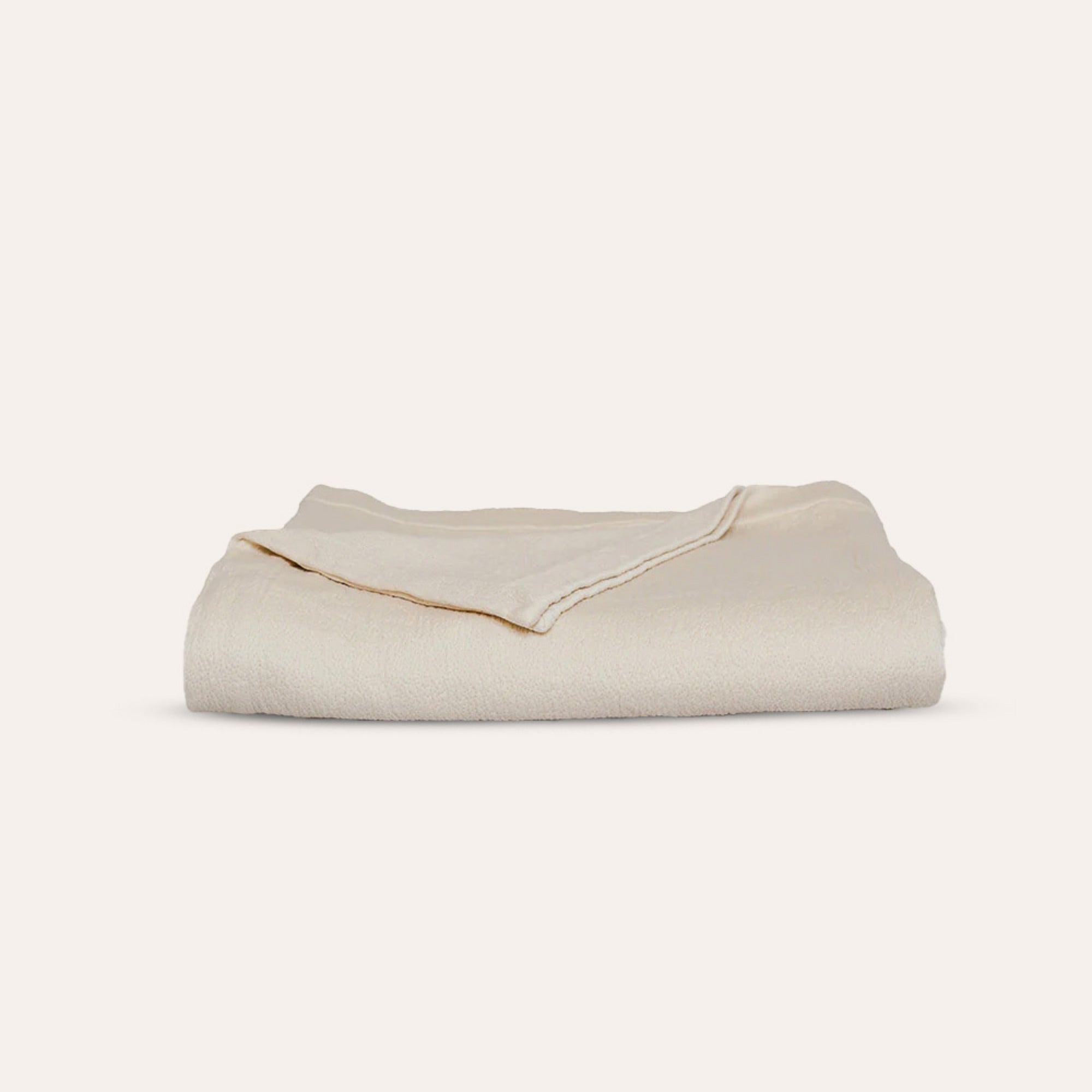 Waves Quilt folded to highlight breathable organic cotton fabric and refined quilting by Rest &amp; Reset