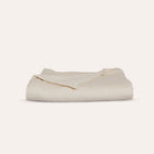 Waves Quilt folded to highlight breathable organic cotton fabric and refined quilting by Rest & Reset