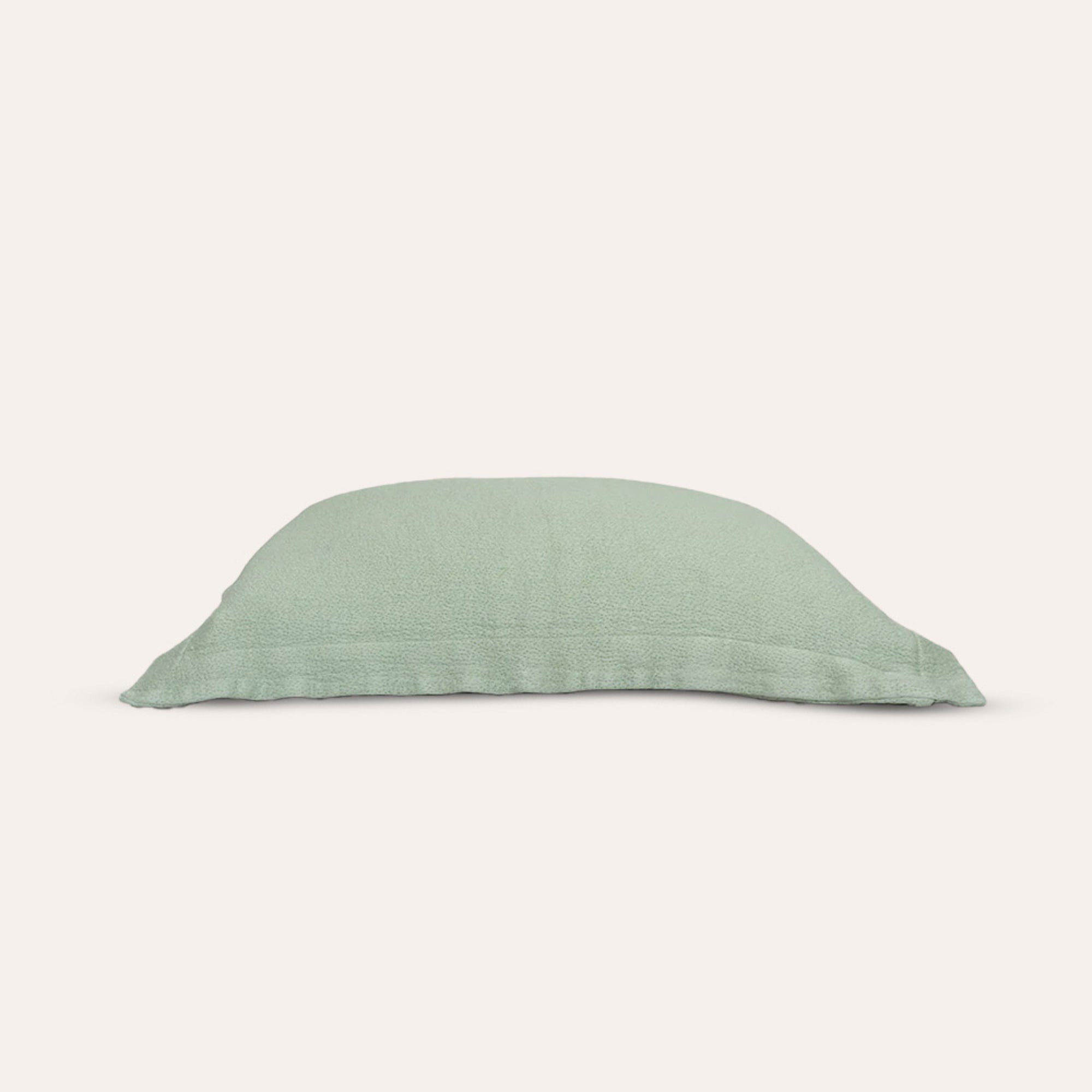Waves Pillow Sham by Rest & Reset shown folded in an alternate tone, maintaining a calm and modern aesthetic