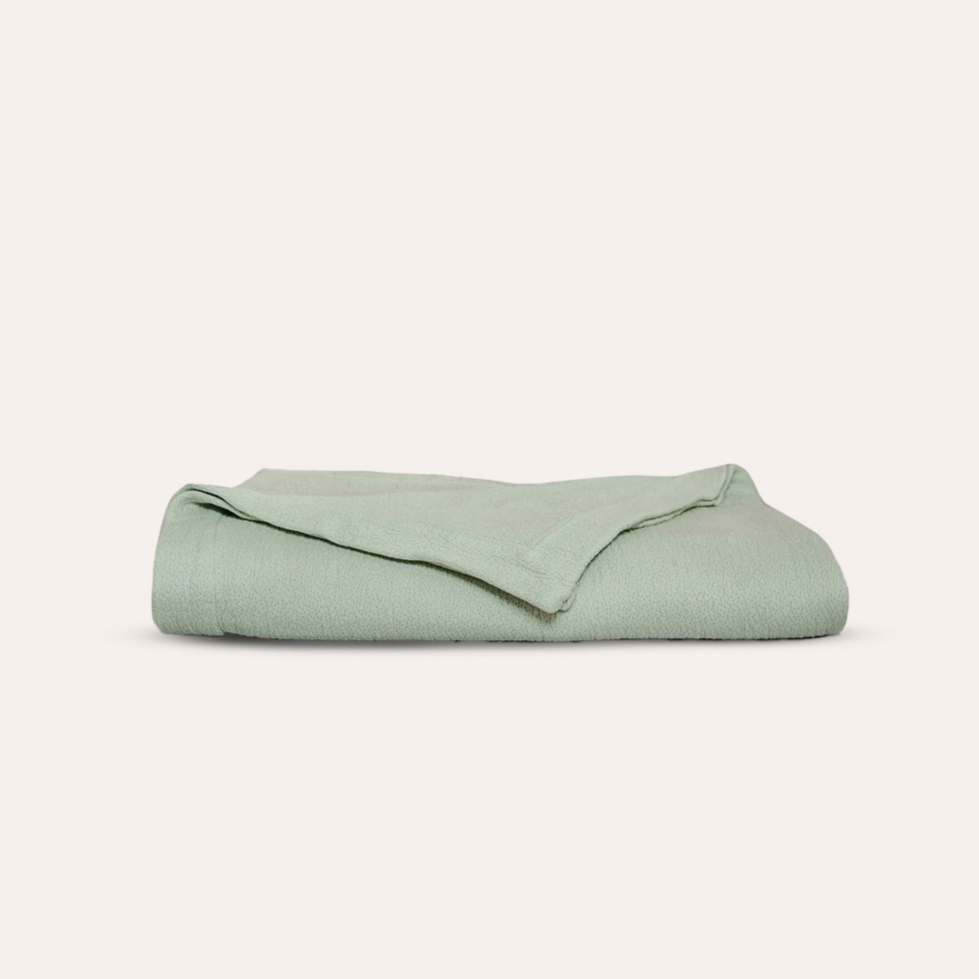 Organic cotton Waves Quilt layered on bed as part of a luxury bedding setup by Rest &amp; Reset
