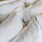 Close-up of organic cotton fabric on Waves Euro Sham by Rest & Reset in use, showing natural drape and softness