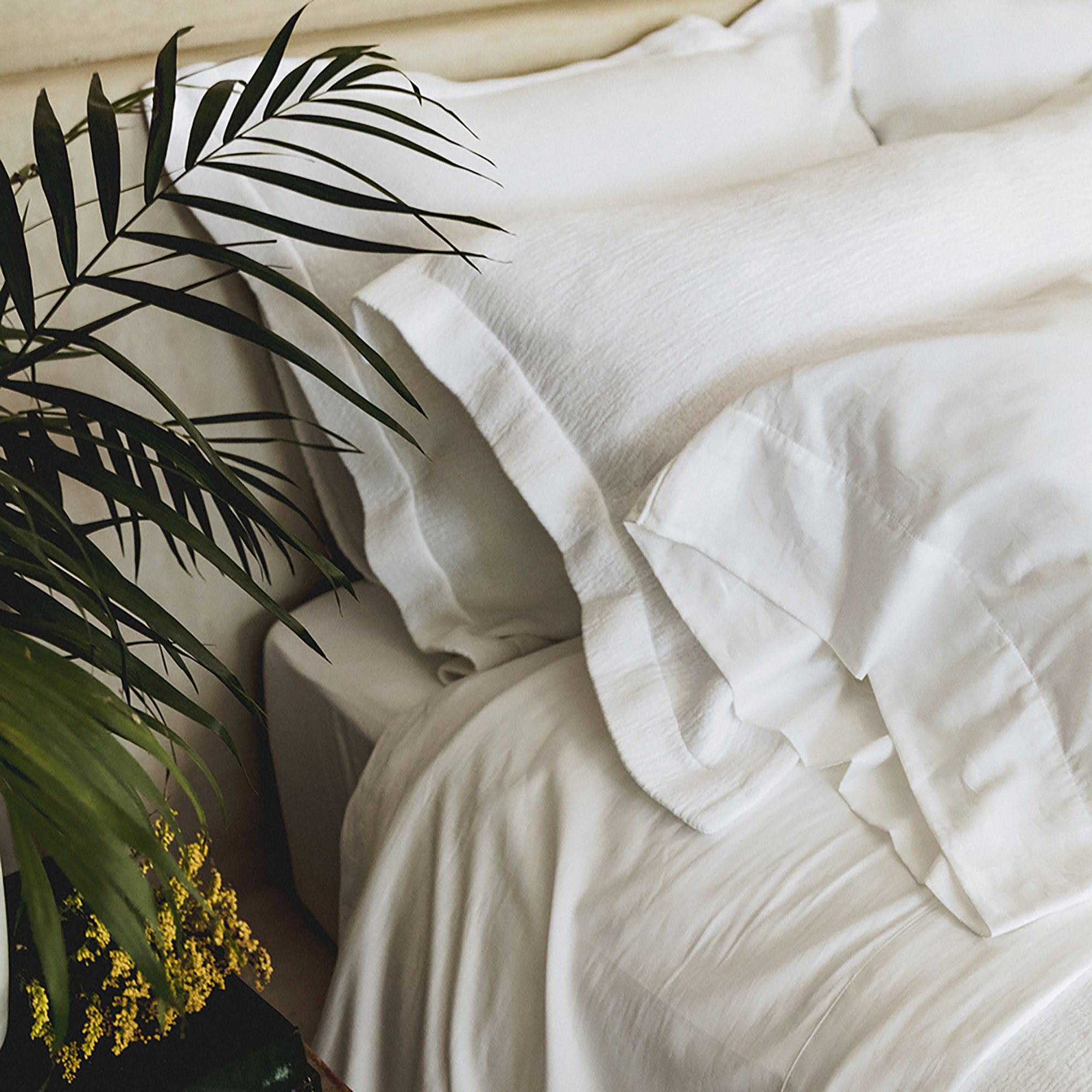 Waves Pillow Sham by Rest & Reset styled with natural elements, enhancing a calm and organic bedroom feel