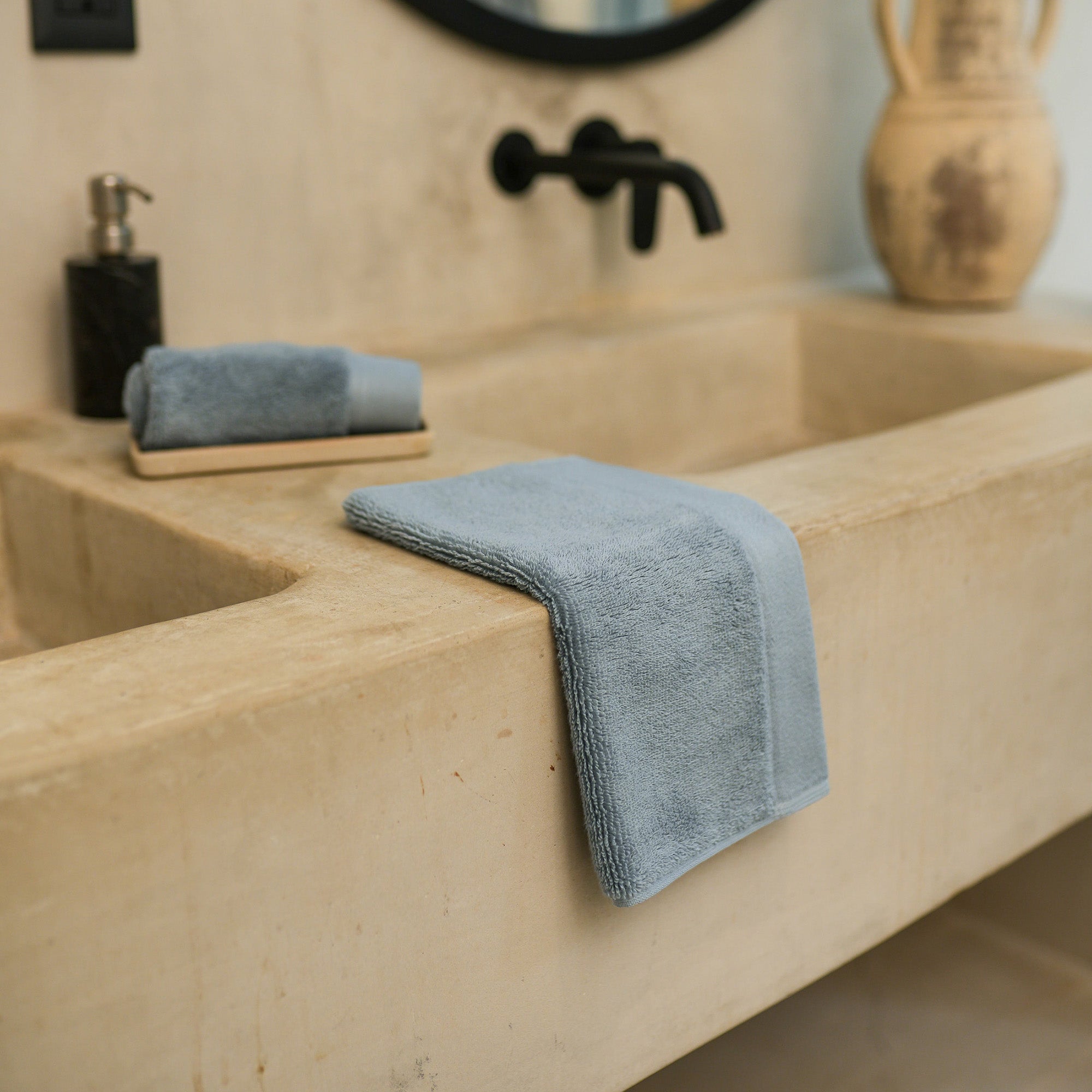 Oasis Washcloths Pair by Rest & Reset styled by the sink, creating a clean and calming bathroom aesthetic