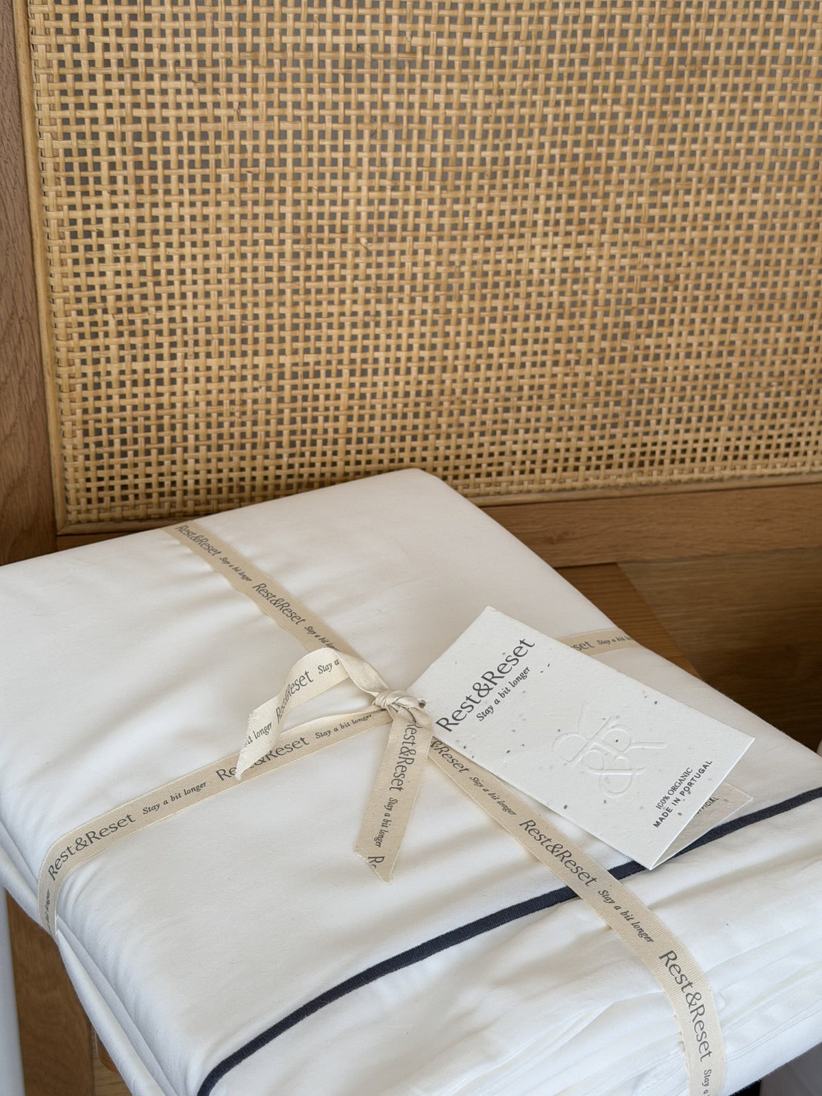 Rest & Reset bedding tied with signature ribbon inside the gift box